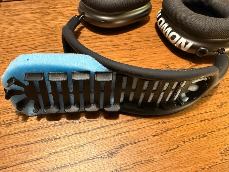 PillowPod components: black insert with blue foam, next to AirPods Max